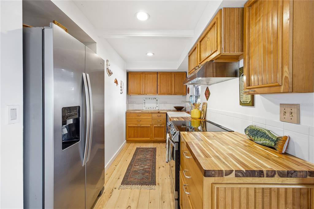 23422 Northeast 154th Place Road Salt Springs, FL 32134 - Photo 9 of 29 a kitchen with stainless steel appliances granite countertop a refrigerator a sink and a stove