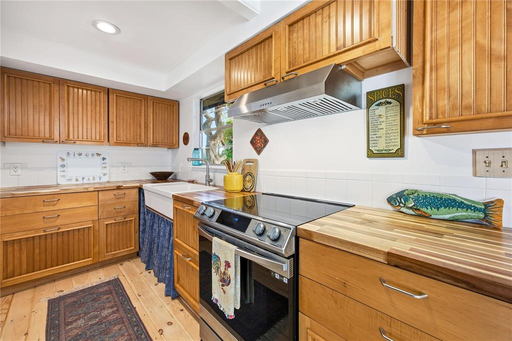 23422 Northeast 154th Place Road Salt Springs, FL 32134 - Photo 10 of 29 a kitchen with stainless steel appliances granite countertop a sink a stove and a refrigerator