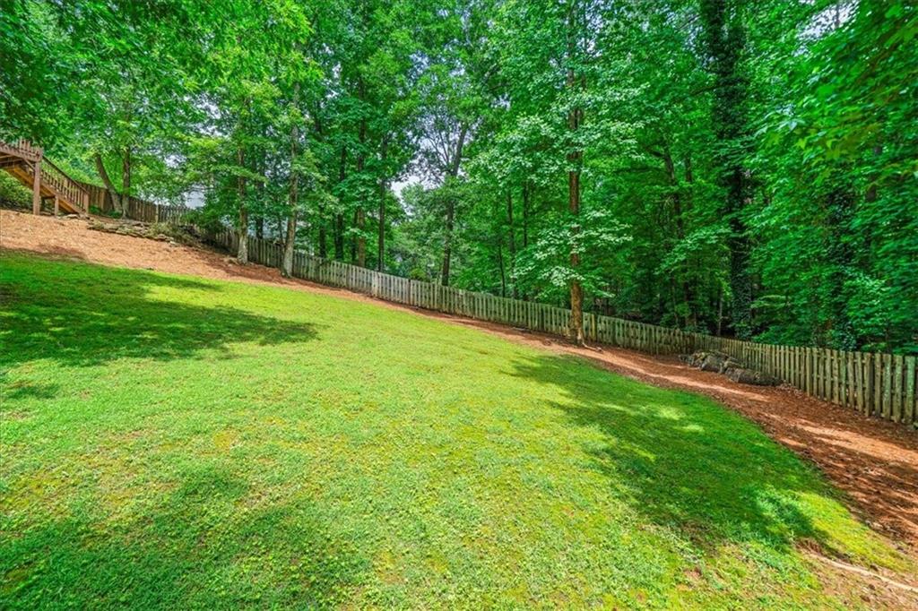1710 Rising Mist Lane Cumming, GA 30041 - Photo 108 of 111 a view of a field with large trees
