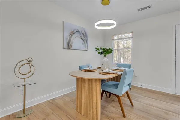 a view of a dining room with furniture and wooden floor