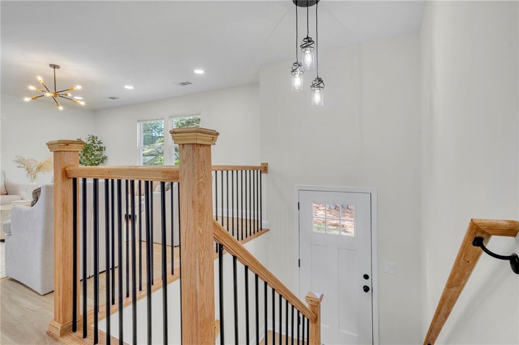 6788 Collier Way Riverdale, GA 30296 - Photo 14 of 37 a view of a hallway with a chandelier