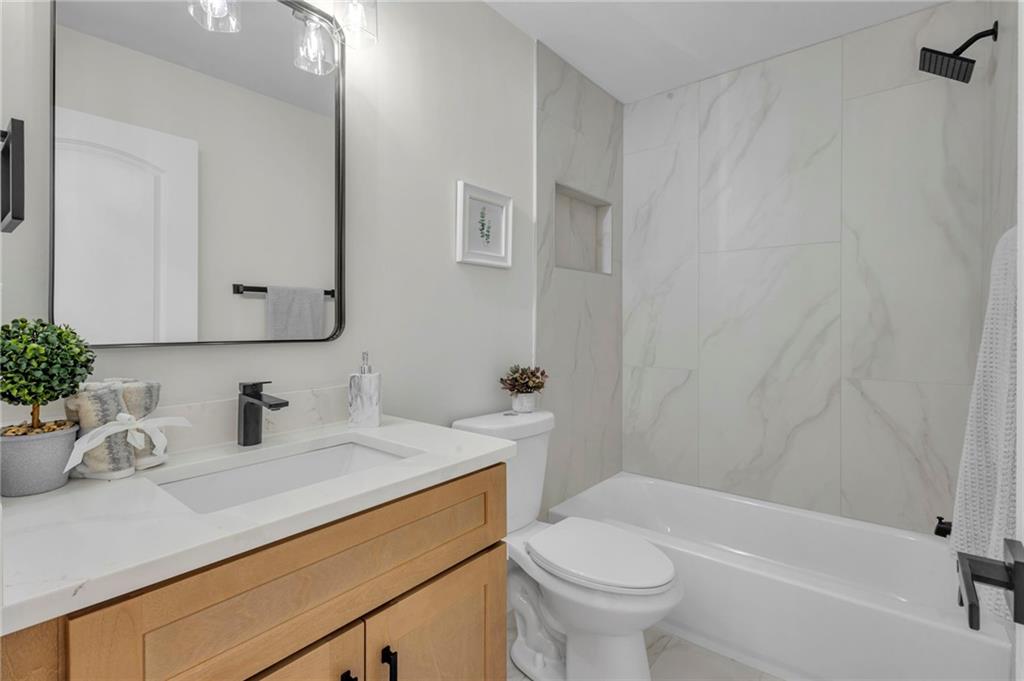 6788 Collier Way Riverdale, GA 30296 - Photo 16 of 37 a bathroom with a sink a toilet and shower