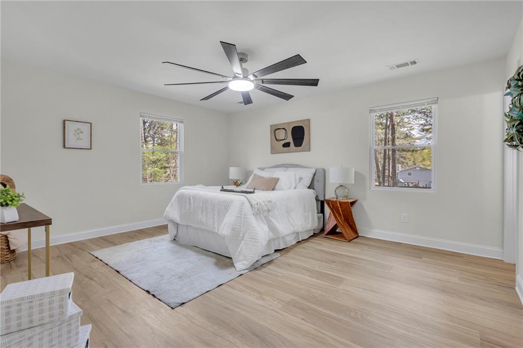 6788 Collier Way Riverdale, GA 30296 - Photo 18 of 37 a bedroom with a bed and a chandelier