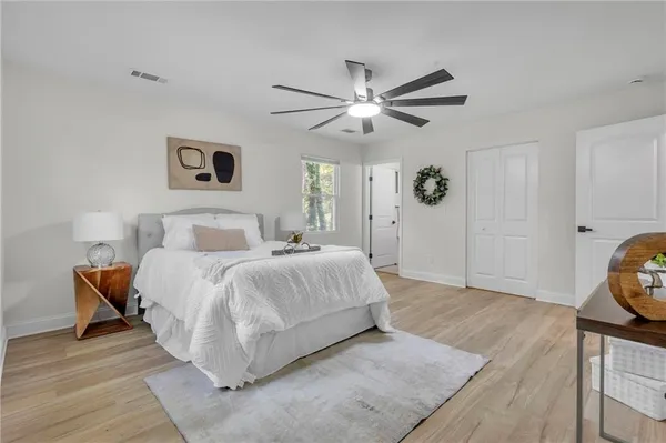a bedroom with a bed and a chandelier