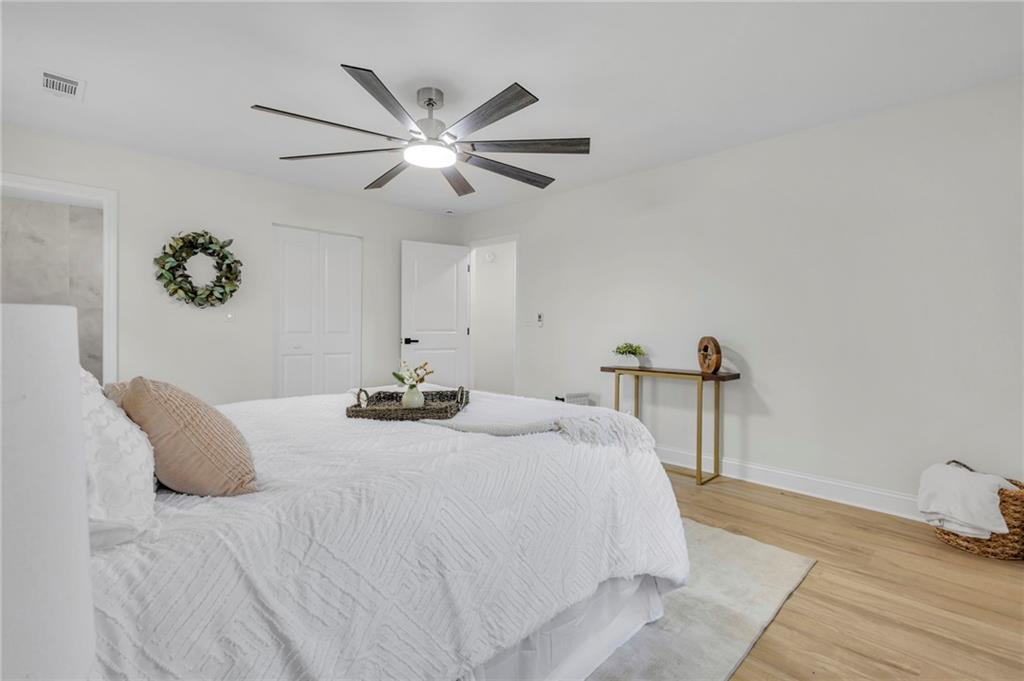 6788 Collier Way Riverdale, GA 30296 - Photo 20 of 37 a bedroom with a bed and a chandelier