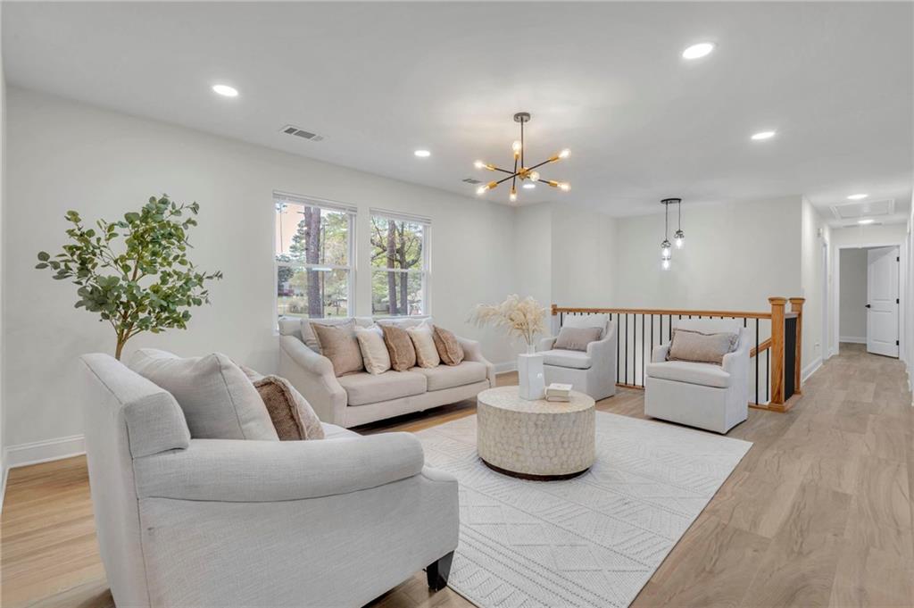 6788 Collier Way Riverdale, GA 30296 - Photo 2 of 37 a living room with furniture and a chandelier