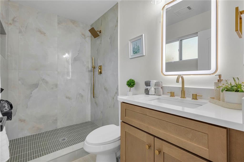 6788 Collier Way Riverdale, GA 30296 - Photo 21 of 37 a bathroom with a granite countertop sink a toilet and shower