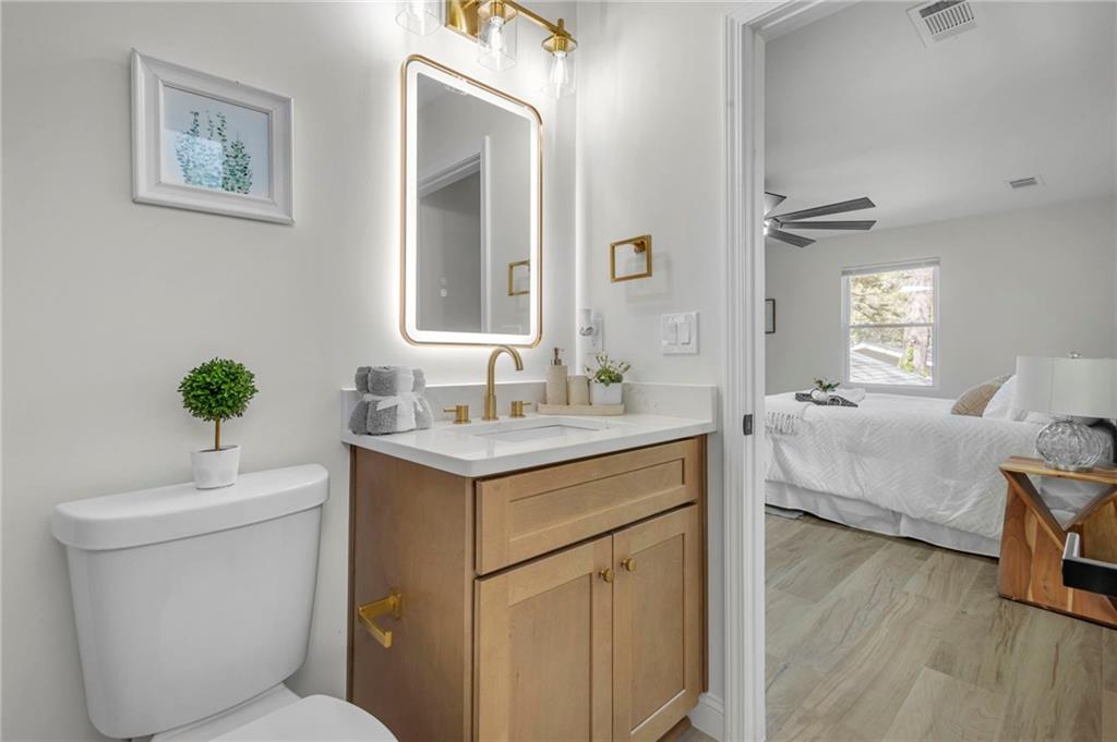 6788 Collier Way Riverdale, GA 30296 - Photo 22 of 37 a bathroom with a sink toilet and vanity