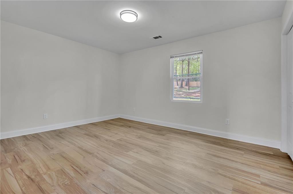 6788 Collier Way Riverdale, GA 30296 - Photo 26 of 37 an empty room with wooden floor and windows