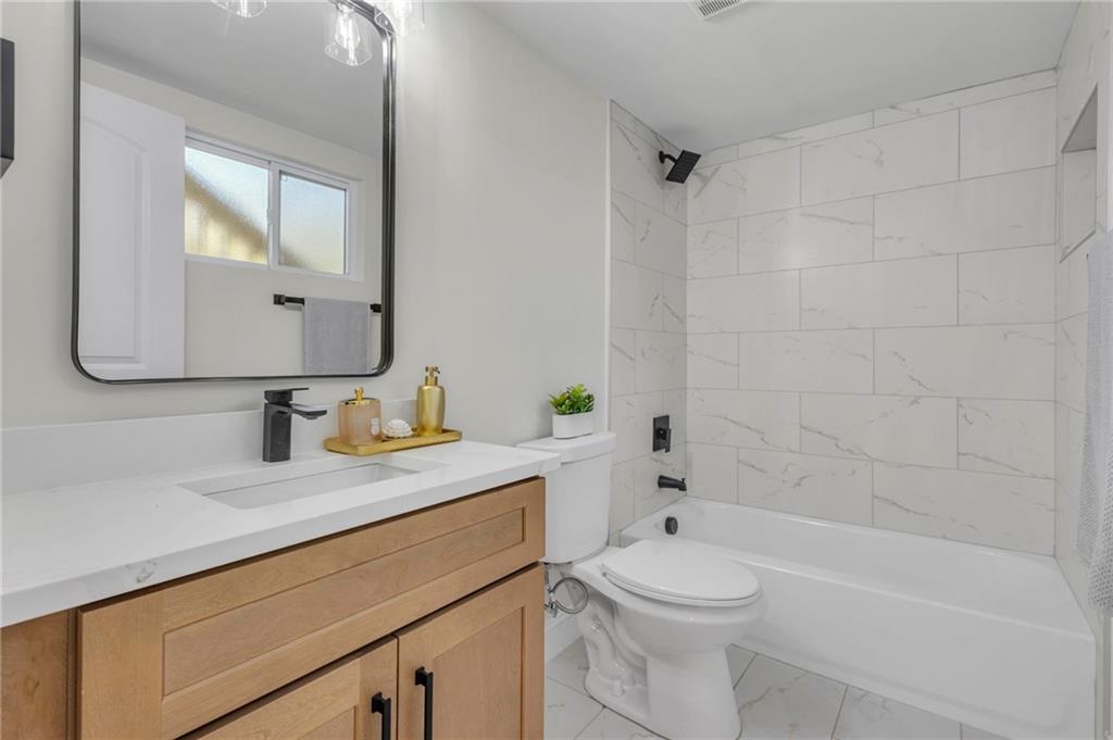 6788 Collier Way Riverdale, GA 30296 - Photo 27 of 37 a bathroom with a sink a toilet and shower
