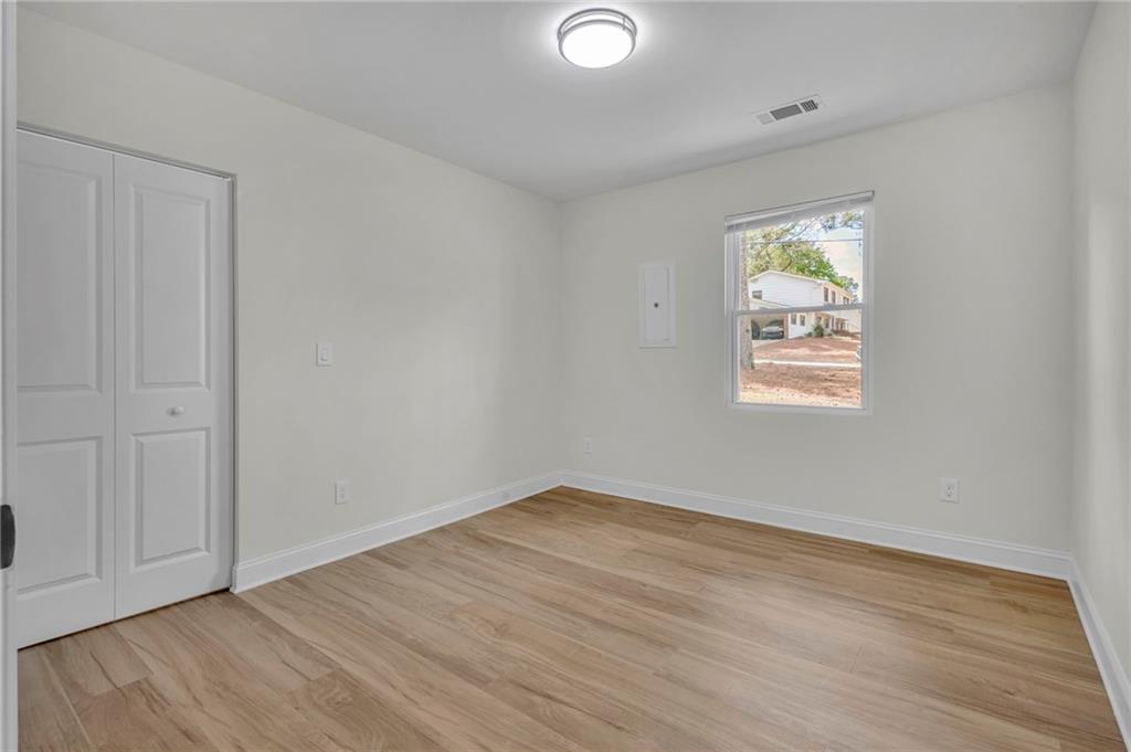 6788 Collier Way Riverdale, GA 30296 - Photo 28 of 37 an empty room with wooden floor and windows