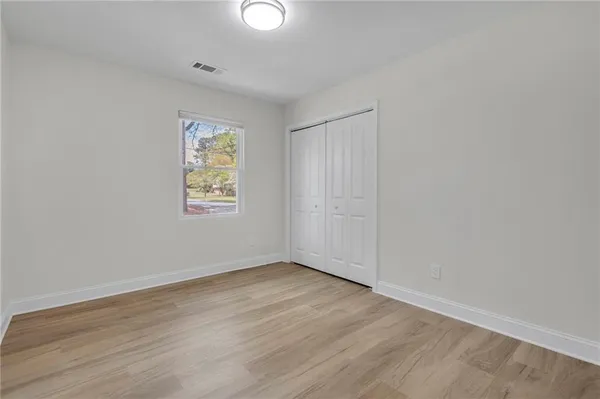 a view of a livingroom with a window and wooden floor