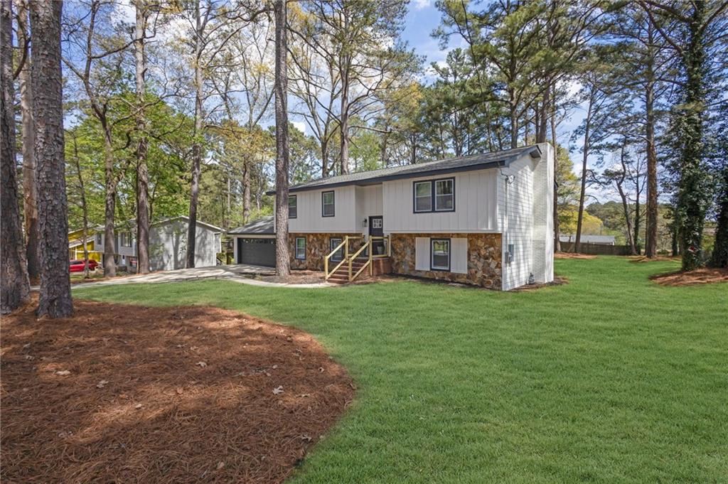 6788 Collier Way Riverdale, GA 30296 - Photo 37 of 37 a view of a house with backyard and a tree