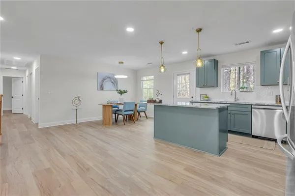 a view of kitchen with cabinets and wooden floor
