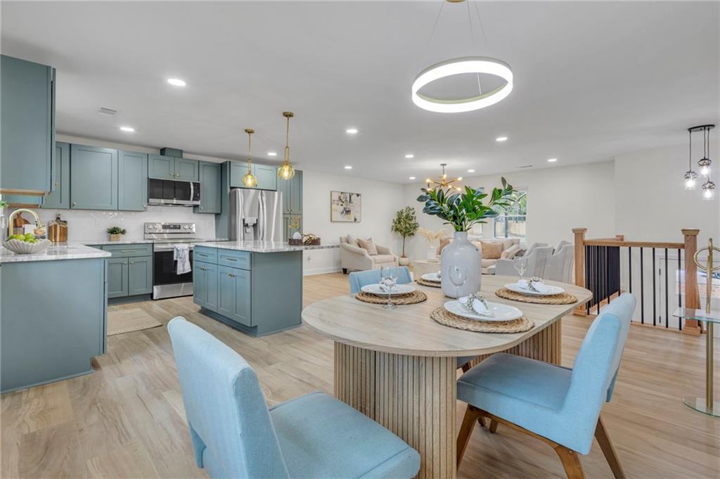 6788 Collier Way Riverdale, GA 30296 - Photo 9 of 37 a view of a dining room with furniture and wooden floor
