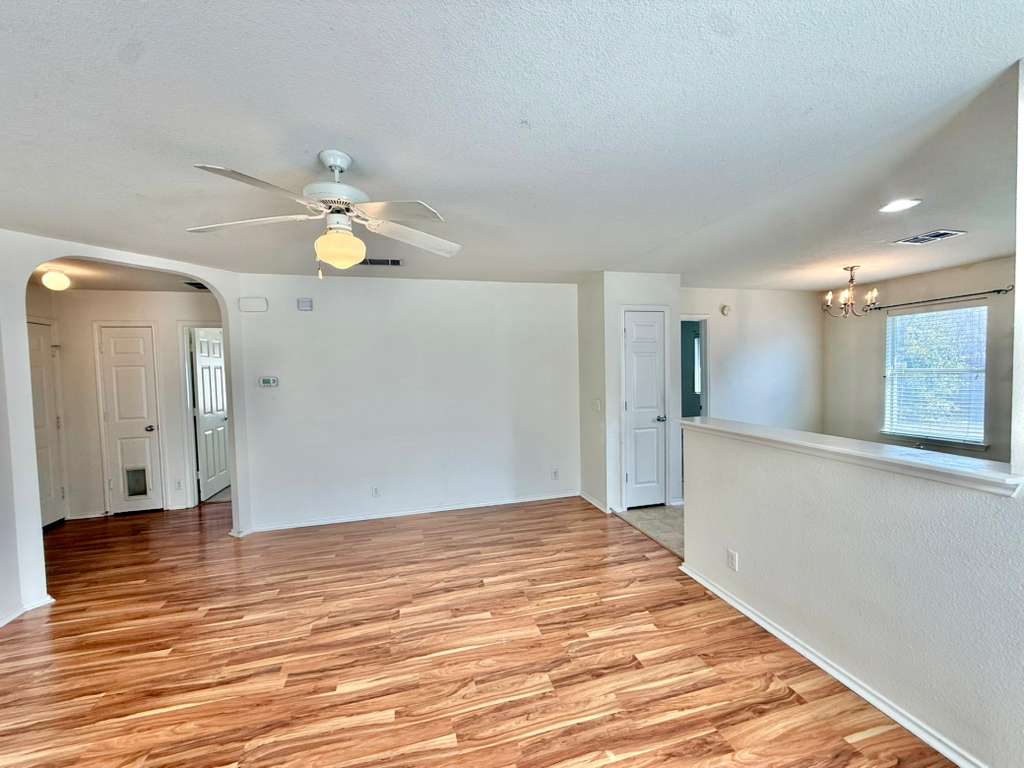 8501 Shallot Way Austin, TX 78748 - Photo 12 of 26 a view of a kitchen with wooden floor and a ceiling fan