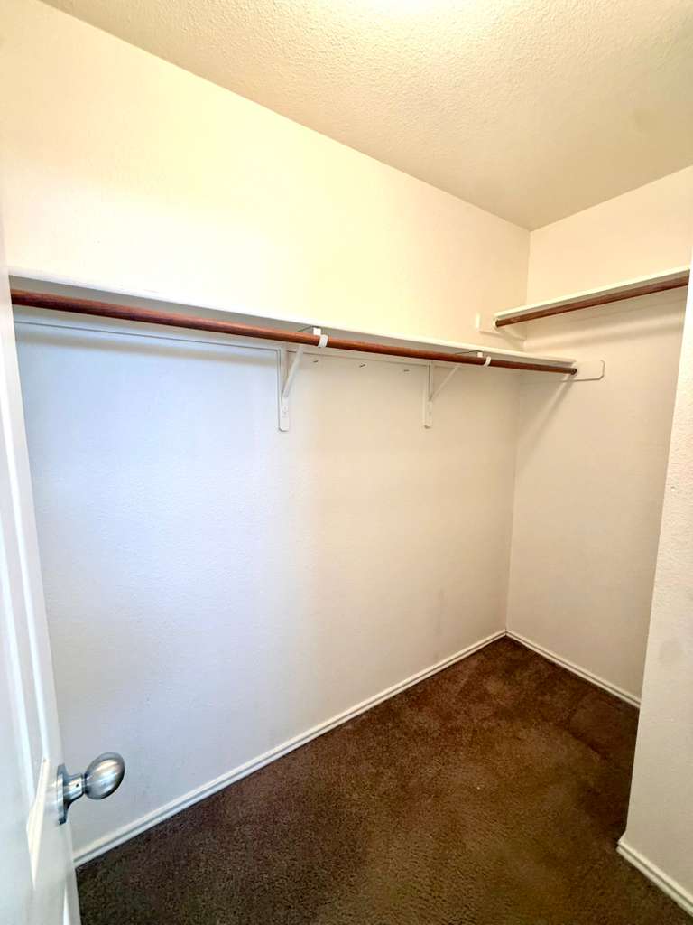 8501 Shallot Way Austin, TX 78748 - Photo 18 of 26 an empty room with a wooden floor and door