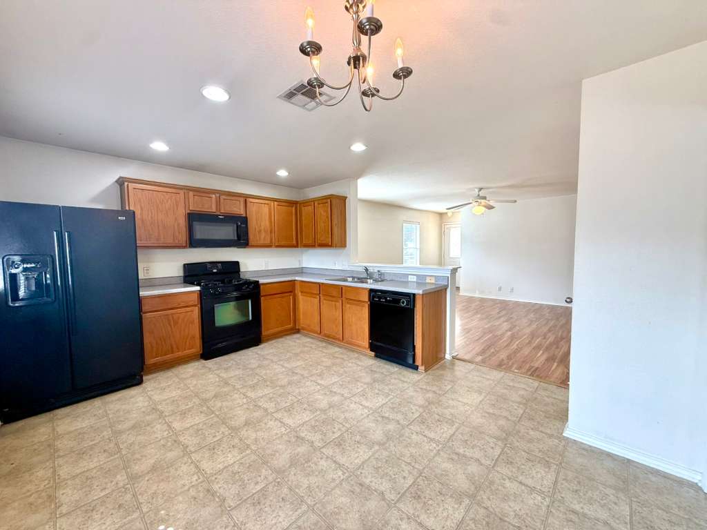 8501 Shallot Way Austin, TX 78748 - Photo 4 of 26 a large kitchen with stainless steel appliances kitchen island granite countertop a refrigerator and a sink