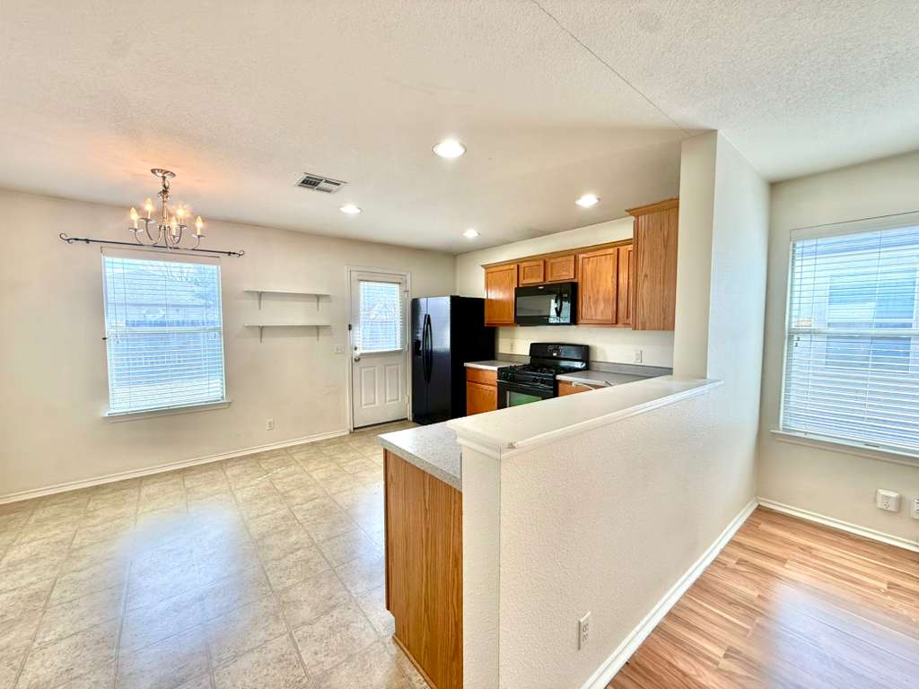 8501 Shallot Way Austin, TX 78748 - Photo 5 of 26 a kitchen with stainless steel appliances granite countertop a refrigerator sink and cabinets