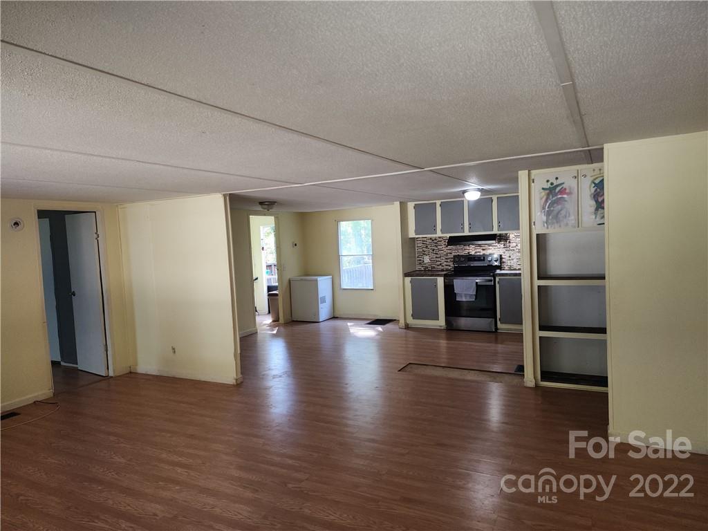 595 Woodglenn Road Catawba, SC 29704 - Photo 3 of 23 a view of a kitchen with a stove fridge and wooden floor