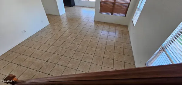 en empty room with windows and fan