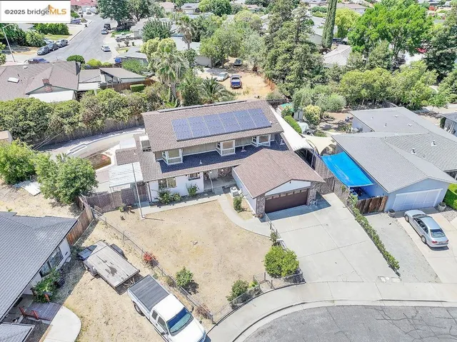 an aerial view of multiple houses with yard
