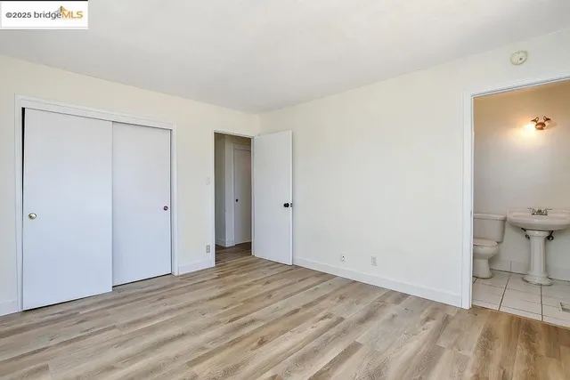 a view of a room with wooden floor and bathroom