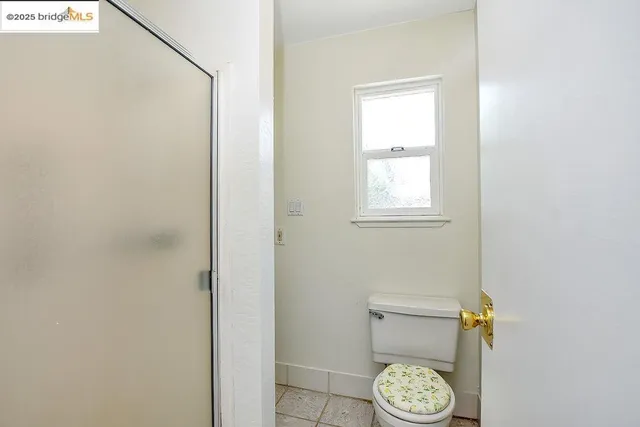 a bathroom with a toilet and a window