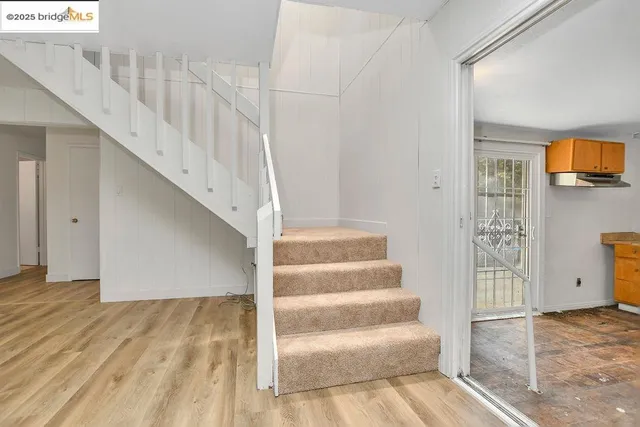 a view of entryway and hall with wooden floor