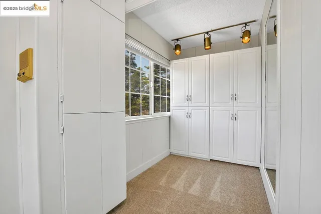 a view of a utility room with cabinet