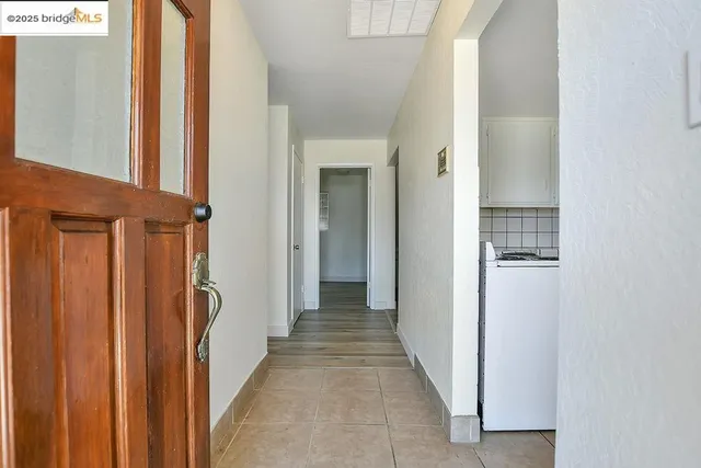 a view of a hallway with wooden floor and entryway