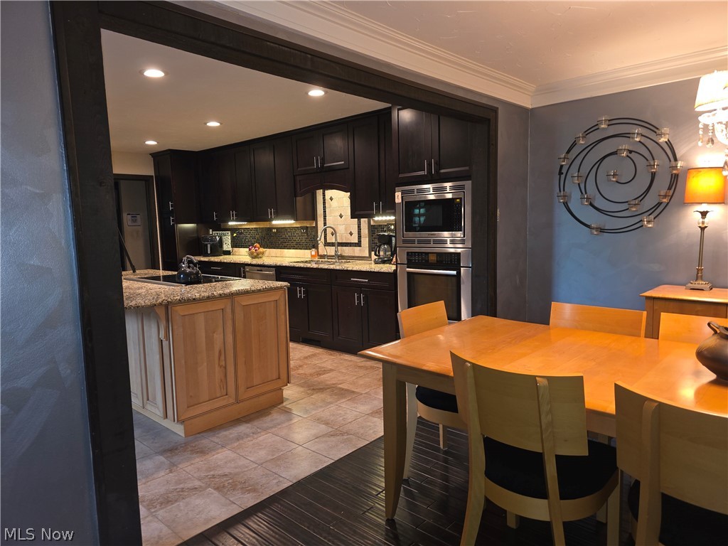 2868 Shade Road Akron, OH 44333 - Photo 22 of 49 Kitchen with dark wood cabinetry and stainless steel appliances