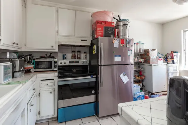 a kitchen with stainless steel appliances and cabinets