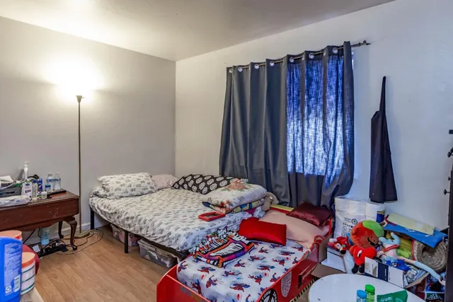 a bedroom with bed and a window