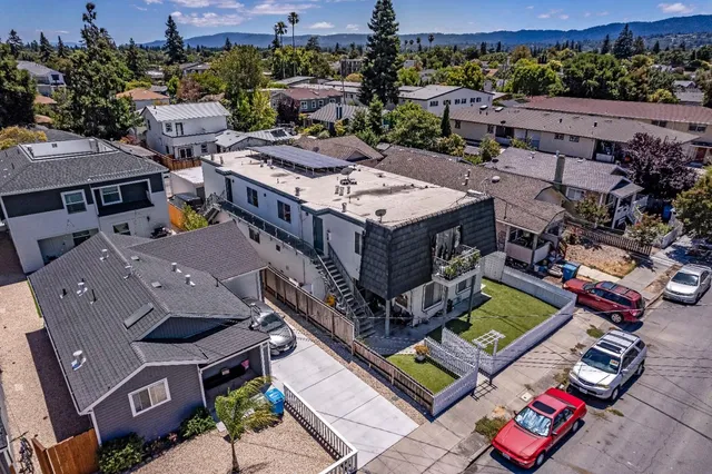 an aerial view of multiple houses with yard