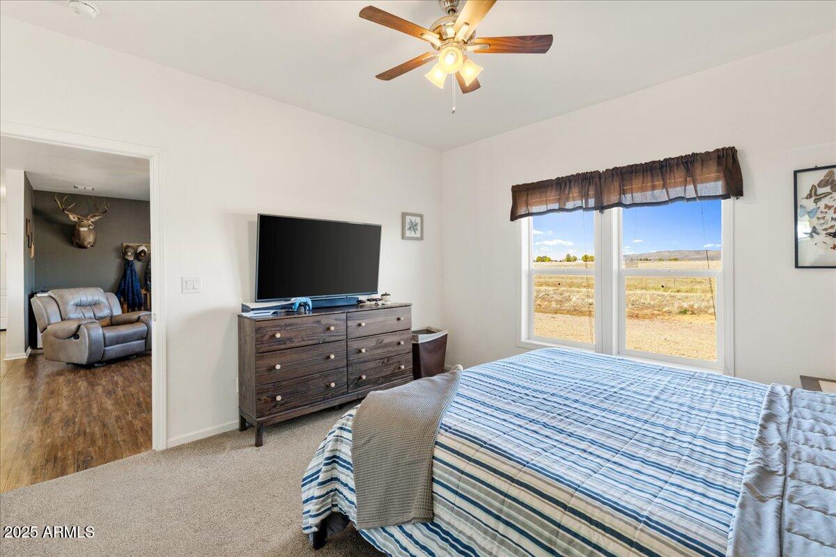 3107 West Country Quail Trail Paulden, AZ 86334 - Photo 14 of 46 a bedroom with a bed and a flat screen tv
