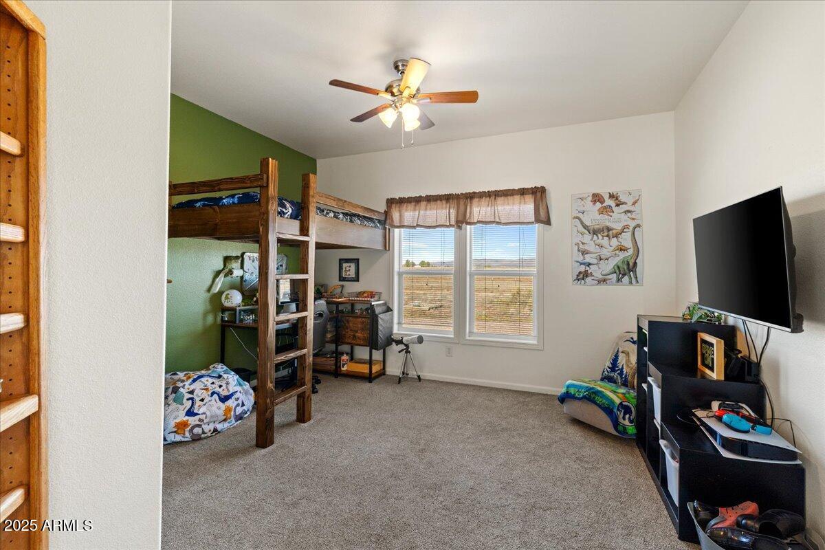 3107 West Country Quail Trail Paulden, AZ 86334 - Photo 17 of 46 a bedroom with furniture and a flat screen tv