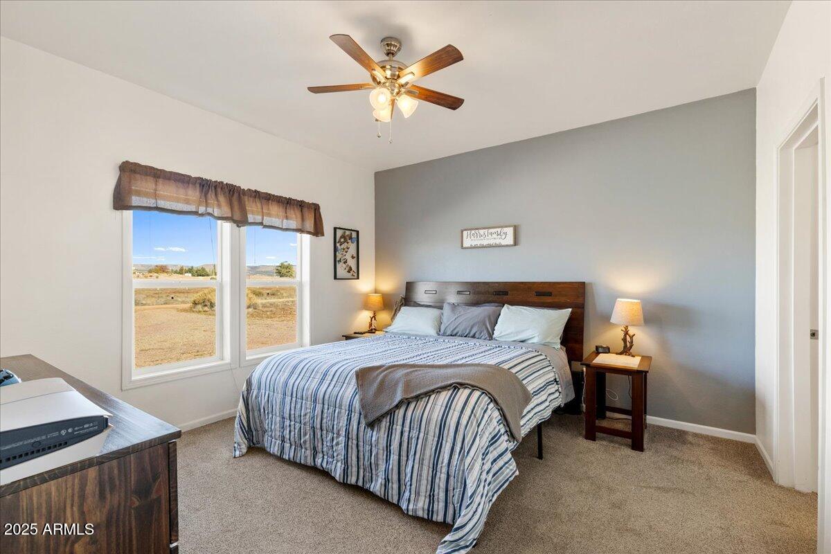 3107 West Country Quail Trail Paulden, AZ 86334 - Photo 19 of 46 a bedroom with a bed and a window