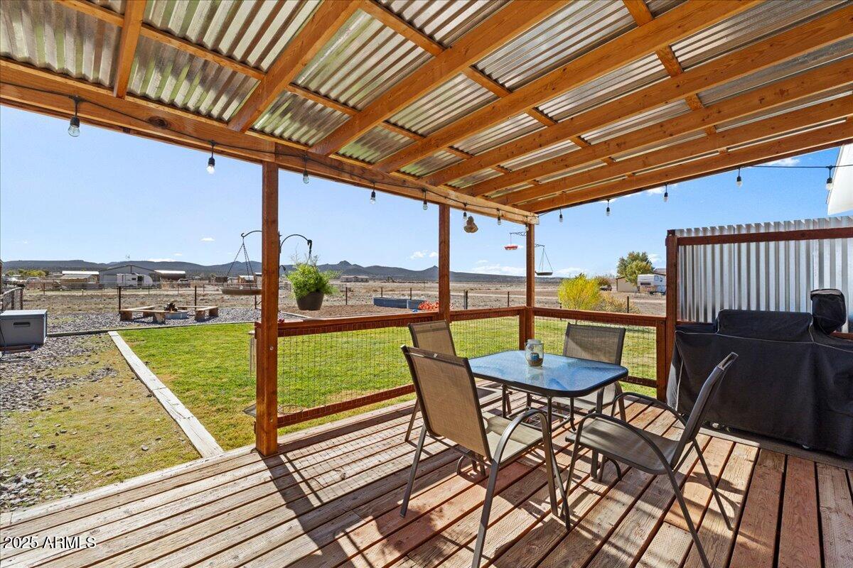 3107 West Country Quail Trail Paulden, AZ 86334 - Photo 25 of 47 a view of a patio with a table chairs and wooden fence