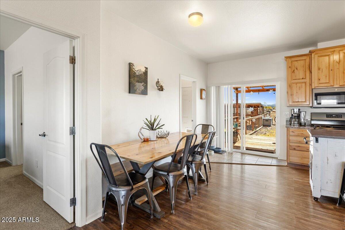 3107 West Country Quail Trail Paulden, AZ 86334 - Photo 10 of 46 a view of a dining room with furniture window and wooden floor