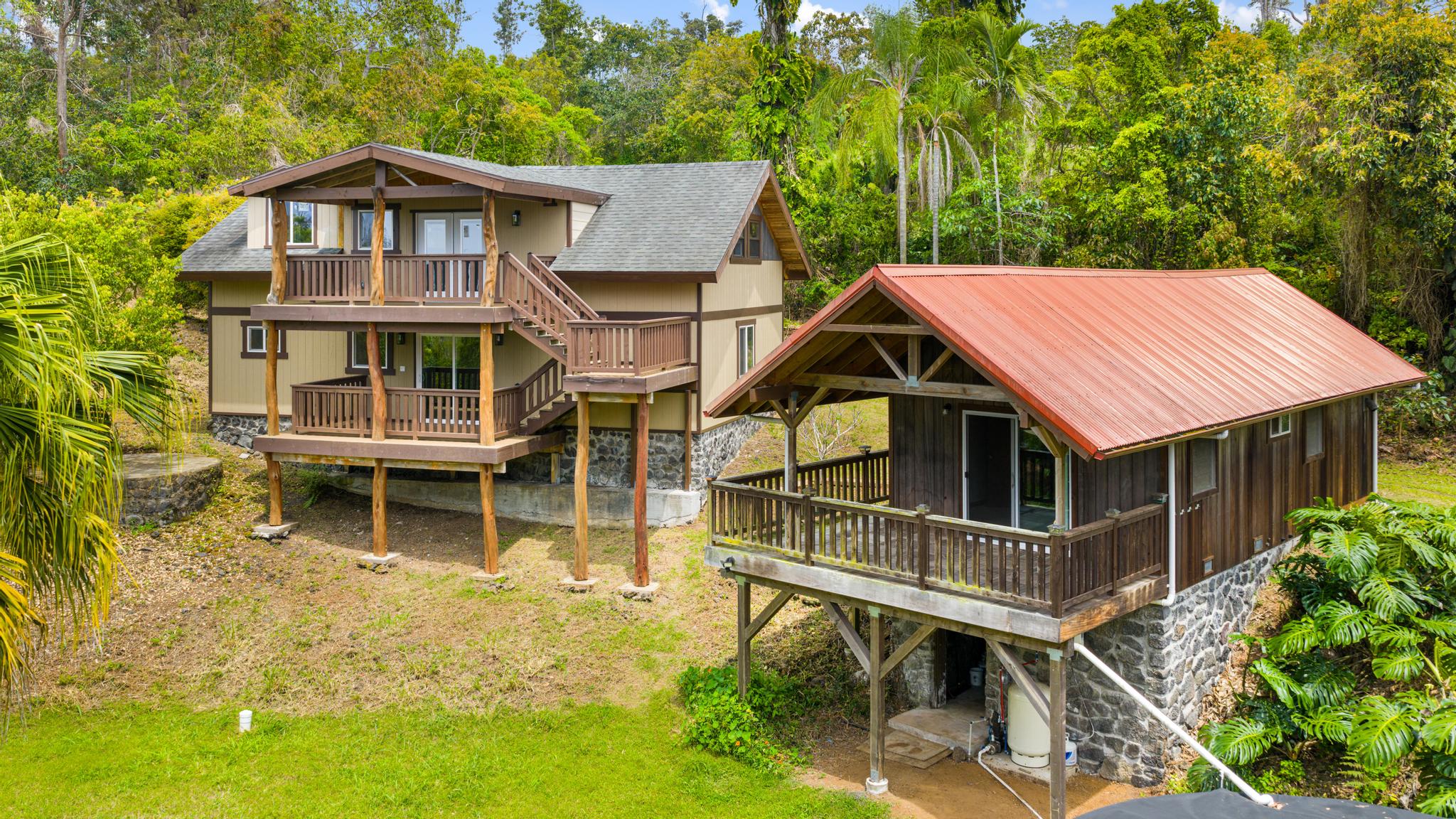an aerial view of a house with a yard table and chairs