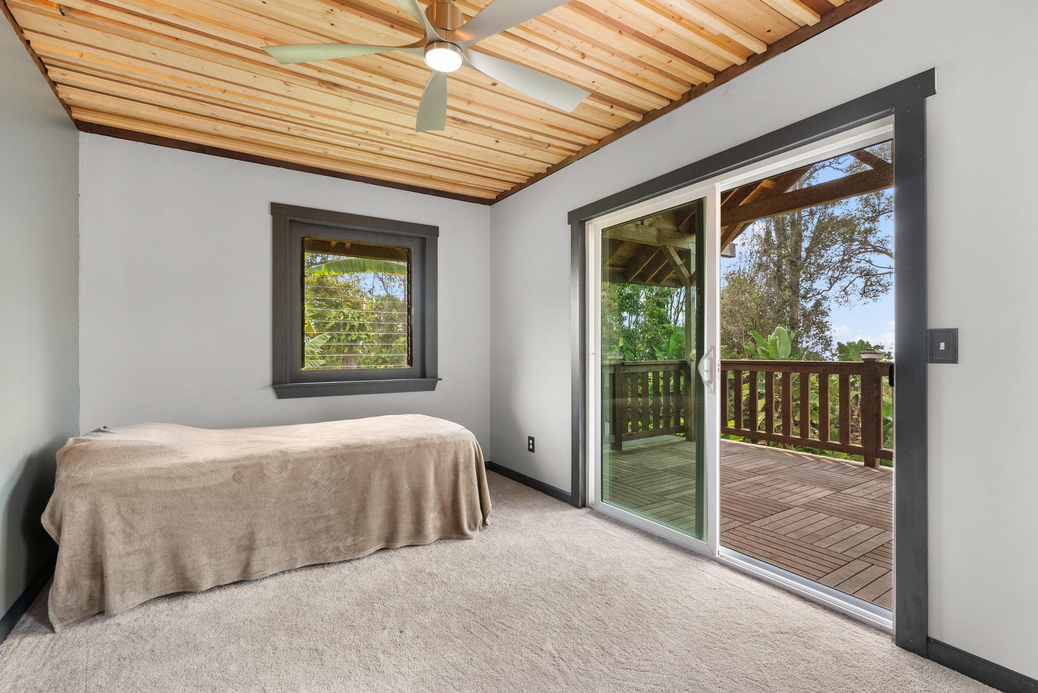 89-811 Huanui Road Captain Cook, HI 96704 - Photo 14 of 30 a bedroom with a large bed and a large window