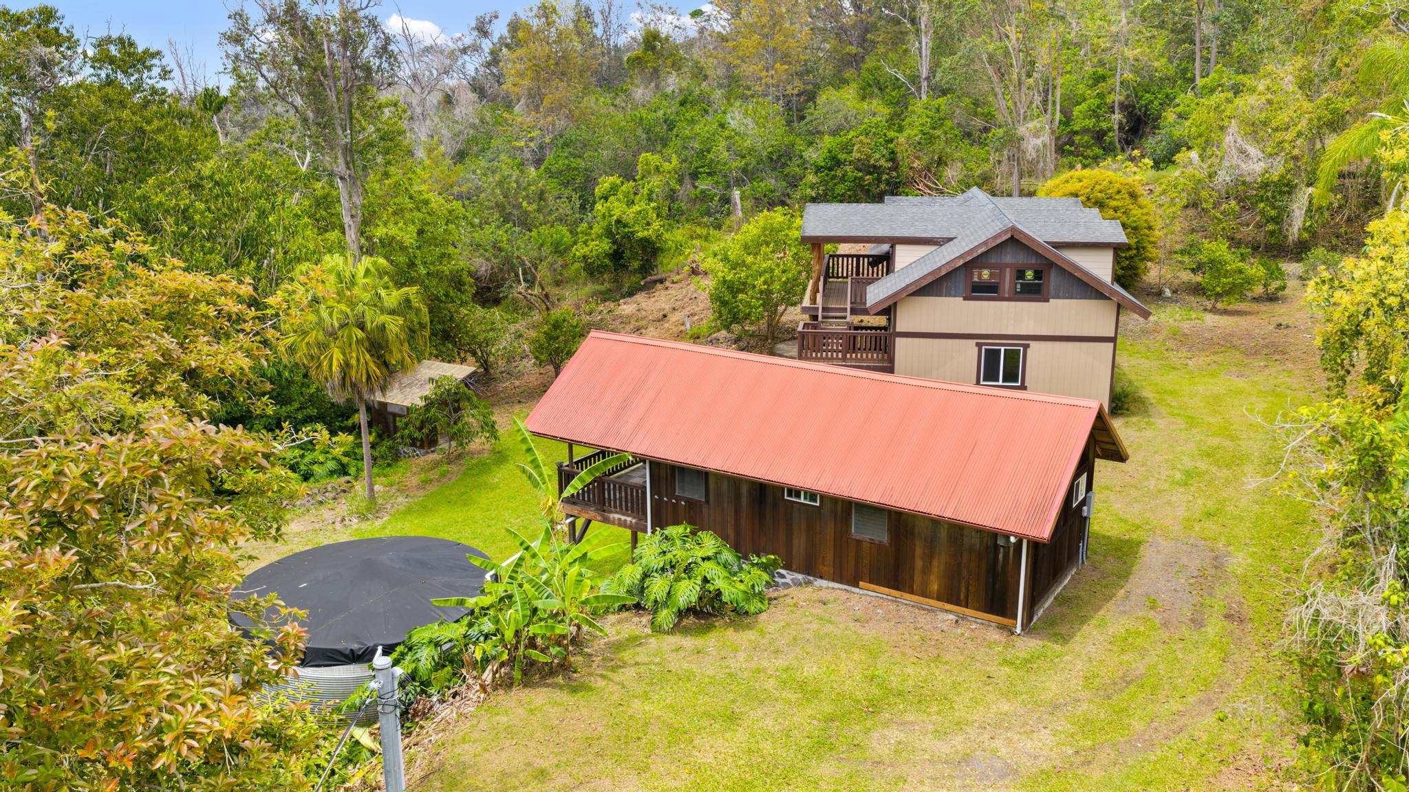 89-811 Huanui Road Captain Cook, HI 96704 - Photo 6 of 30 an aerial view of a house with a yard and trees all around