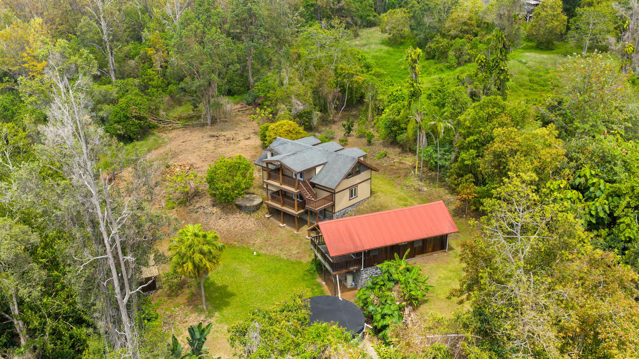 89-811 Huanui Road Captain Cook, HI 96704 - Photo 8 of 30 an aerial view of a house with swimming pool and red chairs