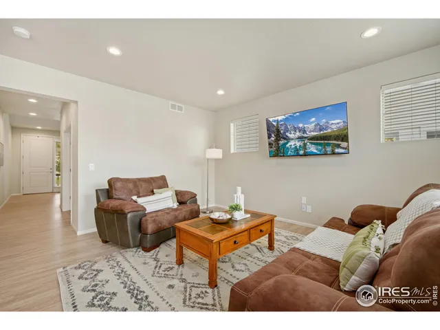 a living room with furniture a couch and wooden floor