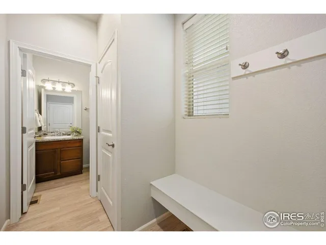 a bathroom with a sink a toilet a mirror and shower