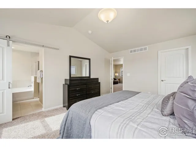 a bedroom with a bed and a television