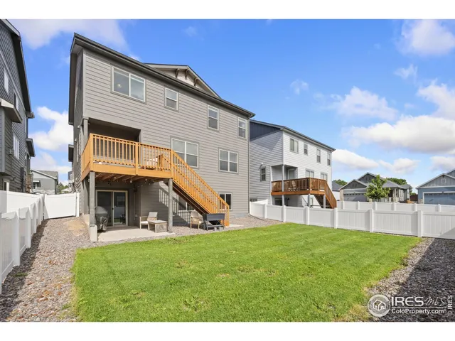 a view of a house with a big yard and large trees