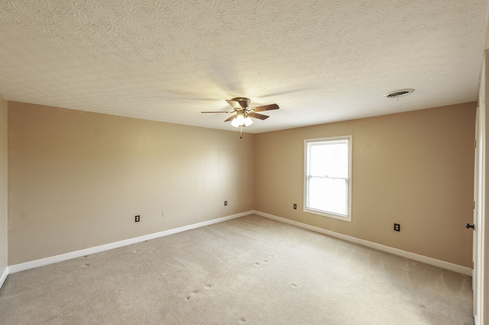 724 Deshea Creek Road Gallatin, TN 37066 - Photo 58 of 76 an empty room with a window and a ceiling fan