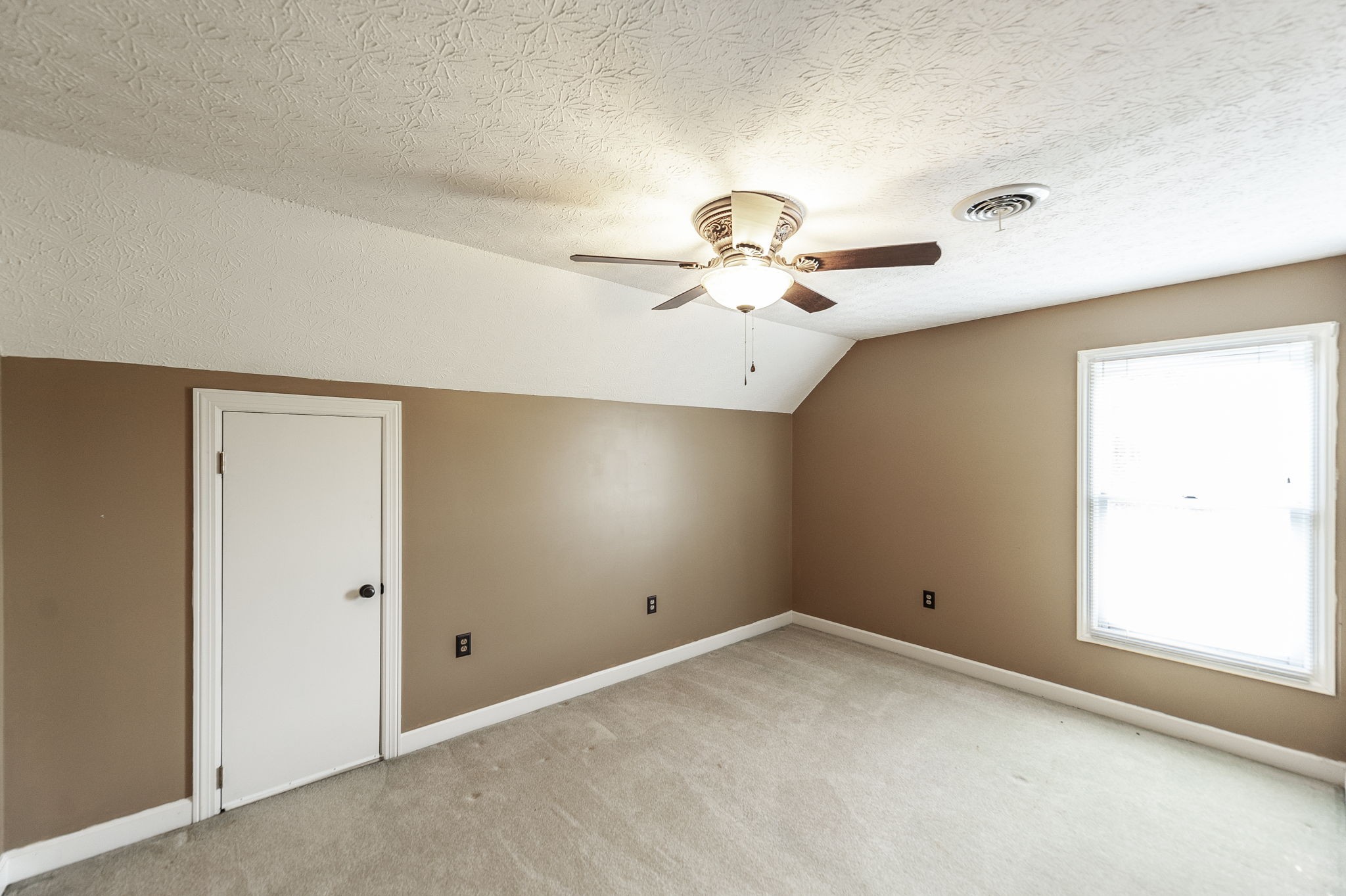 724 Deshea Creek Road Gallatin, TN 37066 - Photo 61 of 76 an empty room with a chandelier fan and windows